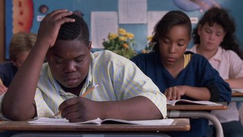 Movie still from “Lean on Me” (1989), directed by John G. Avildsen – A boy and a girl sitting at a desk doing homework; Close Up shot, High angle