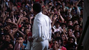 Movie still from “Lean on Me” (1989), directed by John G. Avildsen – A crowd of people sitting and standing in front of an audience; Medium shot, High angle