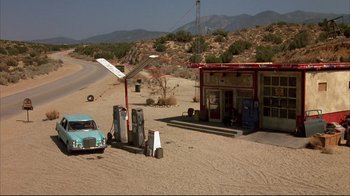Movie still from “Leatherface: Texas Chainsaw Massacre III” (1990), directed by Jeff Burr – An old truck parked in the middle of the desert; Extreme Wide shot, High angle