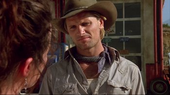 Movie still from “Leatherface: Texas Chainsaw Massacre III” (1990), directed by Jeff Burr – A man wearing a cowboy hat standing next to a woman; Close Up shot, Over the shoulder angle