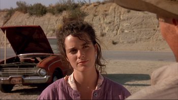 Movie still from “Leatherface: Texas Chainsaw Massacre III” (1990), directed by Jeff Burr – A woman standing in front of an old red car; Close Up shot, Low angle