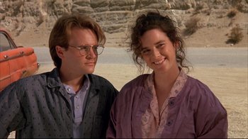 Movie still from “Leatherface: Texas Chainsaw Massacre III” (1990), directed by Jeff Burr – A man and a woman standing next to each other on the beach; Close Up shot, Low angle