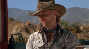 Movie still from “Leatherface: Texas Chainsaw Massacre III” (1990), directed by Jeff Burr – A man wearing a cowboy hat in the desert; Close Up shot, Low angle