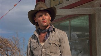 Movie still from “Leatherface: Texas Chainsaw Massacre III” (1990), directed by Jeff Burr – A man wearing a cowboy hat and a neck tie; Close Up shot, Low angle