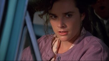 Movie still from “Leatherface: Texas Chainsaw Massacre III” (1990), directed by Jeff Burr – A young woman sitting in the driver's seat of a car; Close Up shot, Low angle