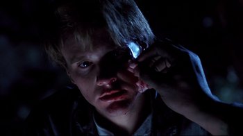 Movie still from “Leatherface: Texas Chainsaw Massacre III” (1990), directed by Jeff Burr – A man with a knife in his hand and blood on his face; Close Up shot, Low angle