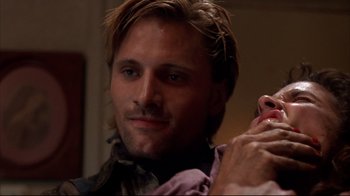 Movie still from “Leatherface: Texas Chainsaw Massacre III” (1990), directed by Jeff Burr – A person with long brown hair; Close Up shot, Over the shoulder angle