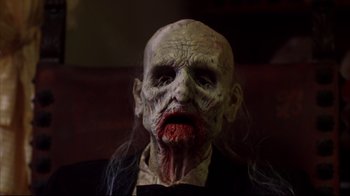 Movie still from “Leatherface: Texas Chainsaw Massacre III” (1990), directed by Jeff Burr – The face of an old man with blood on his mouth; Close Up shot, High angle