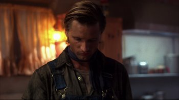 Movie still from “Leatherface: Texas Chainsaw Massacre III” (1990), directed by Jeff Burr – A person wearing a neck scarf; Close Up shot, Over the shoulder angle