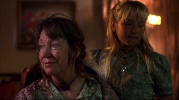 Movie still from “Leatherface: Texas Chainsaw Massacre III” (1990), directed by Jeff Burr – A woman and a girl are sitting in a room together; Close Up shot, Low angle