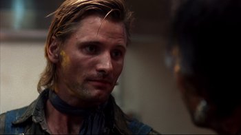 Movie still from “Leatherface: Texas Chainsaw Massacre III” (1990), directed by Jeff Burr – A person with a face paint; Close Up shot, Over the shoulder angle