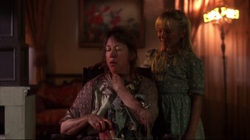Movie still from “Leatherface: Texas Chainsaw Massacre III” (1990), directed by Jeff Burr – A woman sitting in a chair next to a little girl; Close Up shot, Over the shoulder angle