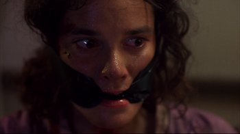 Movie still from “Leatherface: Texas Chainsaw Massacre III” (1990), directed by Jeff Burr – A woman with a black ribbon around her mouth; Close Up shot, Low angle