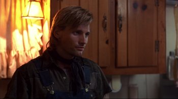 Movie still from “Leatherface: Texas Chainsaw Massacre III” (1990), directed by Jeff Burr – A person in a room near a window; Close Up shot, Over the shoulder angle