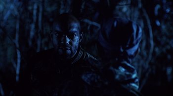 Movie still from “Leatherface: Texas Chainsaw Massacre III” (1990), directed by Jeff Burr – A person in a dark room; Close Up shot, Over the shoulder angle