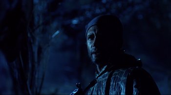 Movie still from “Leatherface: Texas Chainsaw Massacre III” (1990), directed by Jeff Burr – A man with a beard wearing a hat and holding a gun; Close Up shot, Low angle