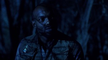 Movie still from “Leatherface: Texas Chainsaw Massacre III” (1990), directed by Jeff Burr – A man with a beard is standing in the dark; Close Up shot, Low angle