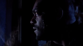 Movie still from “Leatherface: Texas Chainsaw Massacre III” (1990), directed by Jeff Burr – A person's face in the dark; Close Up shot, Low angle