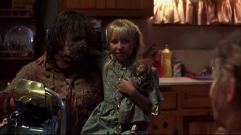Movie still from “Leatherface: Texas Chainsaw Massacre III” (1990), directed by Jeff Burr – A girl holding a stuffed animal in her arms; Medium shot, Over the shoulder angle