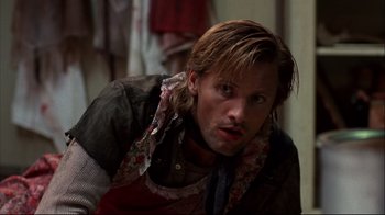Movie still from “Leatherface: Texas Chainsaw Massacre III” (1990), directed by Jeff Burr – A person with a scarf around his neck; Close Up shot, Low angle