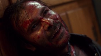Movie still from “Leatherface: Texas Chainsaw Massacre III” (1990), directed by Jeff Burr – A person with blood all over his face; Close Up shot, Overhead angle