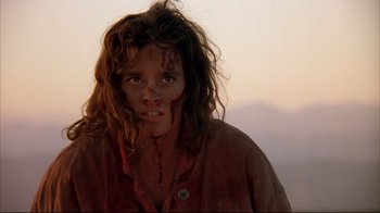 Movie still from “Leatherface: Texas Chainsaw Massacre III” (1990), directed by Jeff Burr – A woman with a wound on her face and long hair; Close Up shot, Low angle