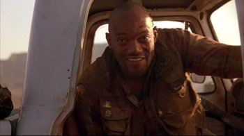 Movie still from “Leatherface: Texas Chainsaw Massacre III” (1990), directed by Jeff Burr – A man in a military uniform smiling for the camera; Close Up shot, Low angle