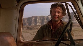 Movie still from “Leatherface: Texas Chainsaw Massacre III” (1990), directed by Jeff Burr – A man is looking out of the window of an old truck; Close Up shot, Low angle