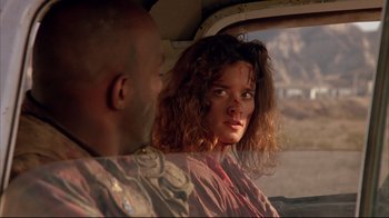 Movie still from “Leatherface: Texas Chainsaw Massacre III” (1990), directed by Jeff Burr – A man and a woman sitting in a vehicle; Close Up shot, Over the shoulder angle