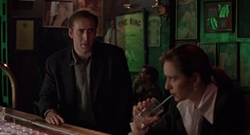 Movie still from “Leaving Las Vegas” (1995), directed by Mike Figgis – A man and a woman sitting at a bar; Medium shot, Over the shoulder angle