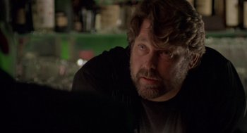 Movie still from “Leaving Las Vegas” (1995), directed by Mike Figgis – A person sitting in a room; Close Up shot, Over the shoulder angle