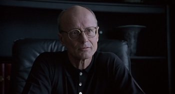 Movie still from “Leaving Las Vegas” (1995), directed by Mike Figgis – An older man wearing glasses sitting in a chair; Close Up shot, Low angle