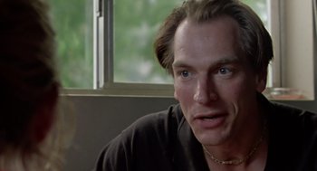 Movie still from “Leaving Las Vegas” (1995), directed by Mike Figgis – A person sitting in front of a window; Close Up shot, Over the shoulder angle