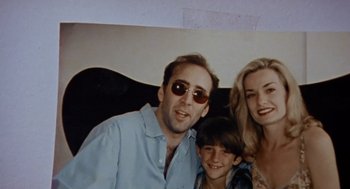 Movie still from “Leaving Las Vegas” (1995), directed by Mike Figgis – A man and a woman and a child pose for a picture; Close Up shot, High angle