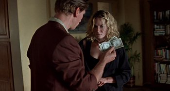 Movie still from “Leaving Las Vegas” (1995), directed by Mike Figgis – A man and a woman are holding money in their hands; Medium shot, Over the shoulder angle