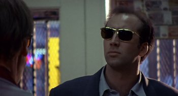 Movie still from “Leaving Las Vegas” (1995), directed by Mike Figgis – A man wearing sunglasses and a suit; Close Up shot, Low angle