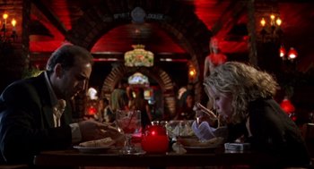 Movie still from “Leaving Las Vegas” (1995), directed by Mike Figgis – A man and a woman sitting at a dinner table; Wide shot, Low angle