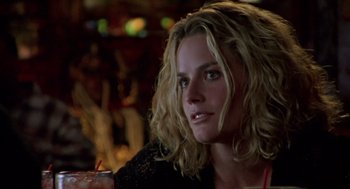 Movie still from “Leaving Las Vegas” (1995), directed by Mike Figgis – A person sitting at a table with a drink; Close Up shot, Over the shoulder angle