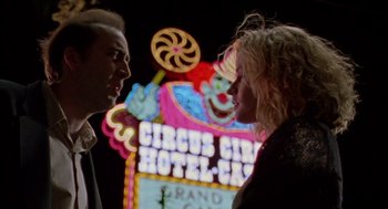 Movie still from “Leaving Las Vegas” (1995), directed by Mike Figgis – A man and a woman standing next to each other in front of a neon sign; Close Up shot, Low angle