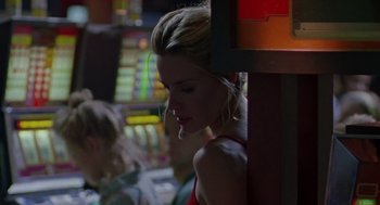 Movie still from “Leaving Las Vegas” (1995), directed by Mike Figgis – A woman standing next to a slot machine in a room; Close Up shot, Low angle
