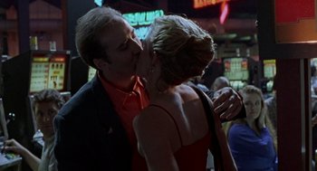 Movie still from “Leaving Las Vegas” (1995), directed by Mike Figgis – A man and a woman are kissing in a bar; Close Up shot, Low angle