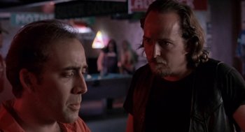 Movie still from “Leaving Las Vegas” (1995), directed by Mike Figgis – Two men are talking in front of a bar; Close Up shot, Over the shoulder angle