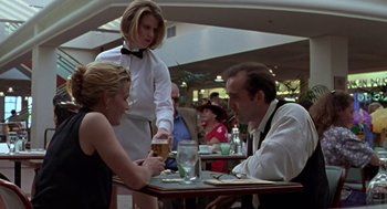 Movie still from “Leaving Las Vegas” (1995), directed by Mike Figgis – A man and a woman at a table in a restaurant; Medium shot, Low angle