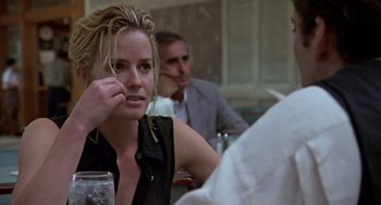 Movie still from “Leaving Las Vegas” (1995), directed by Mike Figgis – A woman sitting in front of a man at a table; Close Up shot, Over the shoulder angle