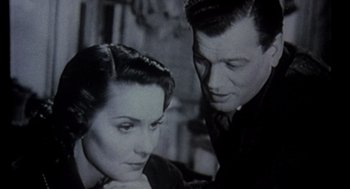 Movie still from “Leaving Las Vegas” (1995), directed by Mike Figgis – An old black and white photo of a man and a woman; Close Up shot, High angle