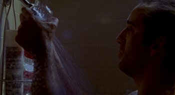 Movie still from “Leaving Las Vegas” (1995), directed by Mike Figgis – A man in the shower with water pouring out of his mouth; Close Up shot, Low angle