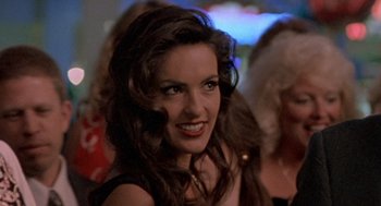 Movie still from “Leaving Las Vegas” (1995), directed by Mike Figgis – A person smiling at a party; Close Up shot, Over the shoulder angle