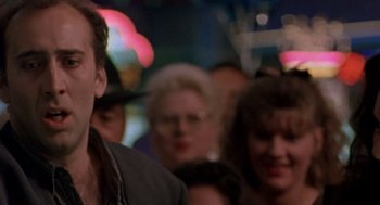 Movie still from “Leaving Las Vegas” (1995), directed by Mike Figgis – A group of people standing in a crowd at night; Close Up shot, Low angle