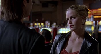 Movie still from “Leaving Las Vegas” (1995), directed by Mike Figgis – A woman wearing a leather jacket standing next to a man; Close Up shot, Over the shoulder angle