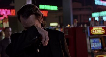 Movie still from “Leaving Las Vegas” (1995), directed by Mike Figgis – A man in a black jacket is holding his head down; Close Up shot, Low angle